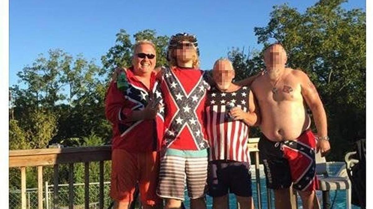 In this Facebook post, Dan Johnson, left, poses with friends wearing clothing with Confederate imagery.