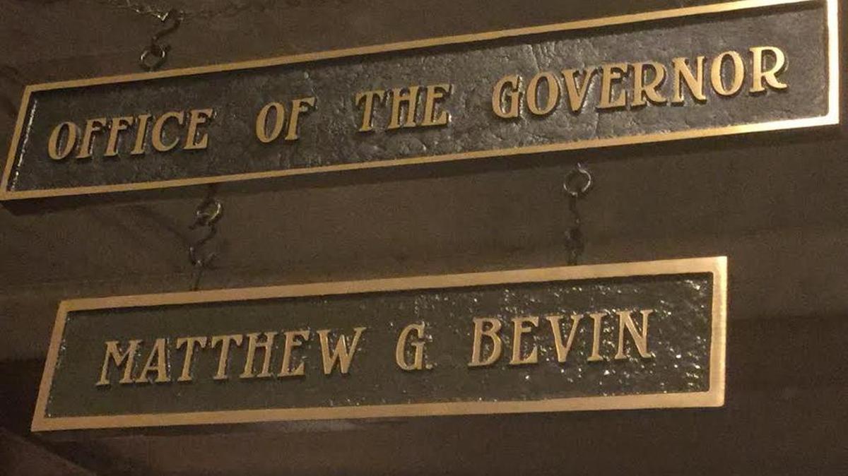A new sign hangs from the front door of the governor's office in the Kentucky Capitol.