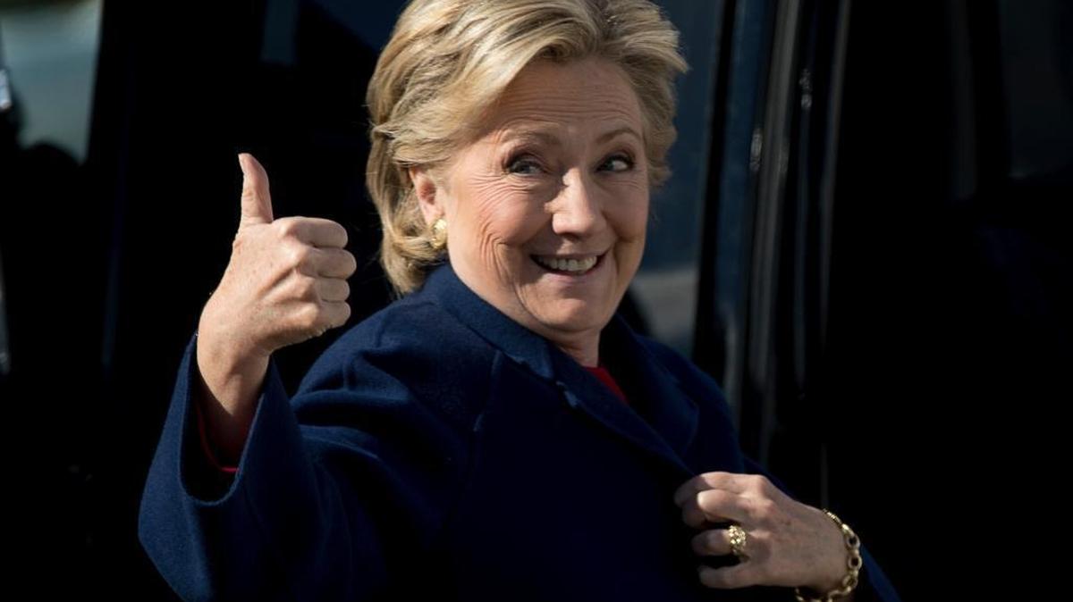 Democratic presidential candidate Hillary Clinton gives a thumbs up as she arrives to board her campaign plane at Westchester County Airport in White Plains, N.Y., Tuesday, Oct. 25, 2016, to travel to Ft. Lauderdale, Fla. for a rally.