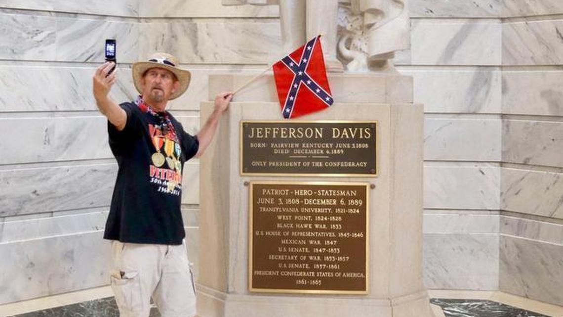 James Hendrickson, Corbin, took a "selfie" with the Jefferson Davis Statue following a rally in support of keeping the statue of Confederate president Jefferson Davis in the Capitol, held on the steps of the State Capitol in Frankfort, Ky., Friday, July 24, 2015. The Kentucky chapter of the Sons of Confederate Veterans organized the rally. After the photo, he attached the flag to the statue.