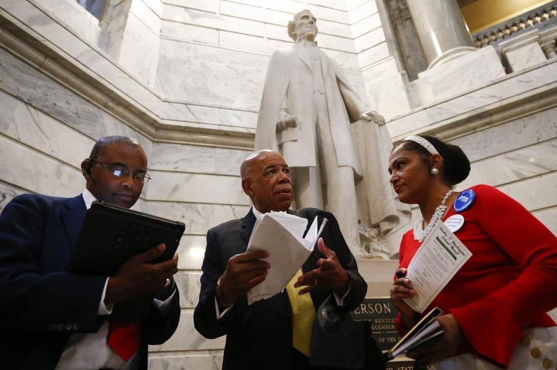 Raoul Cunningham, of Louisville, Ky., president of the Kentucky State Conference of the NAACP, center, prepares to speak while standing in front of a statue of Jefferson Davis with Brenda Martin, of Ashland, Ky., first vice president of the Boyd-Greenup County branch of the NAACP, right, and Marcus Ray, of Elizabethtown, Ky., president of the Hardin County branch of the NAACP, at the Capitol Rotunda in Frankfort, Ky., Wednesday, Aug. 30, 2017. Demonstrators and speakers gathered at the Capitol Rotunda calling for the removal of the Jefferson Davis statue from the capitol.