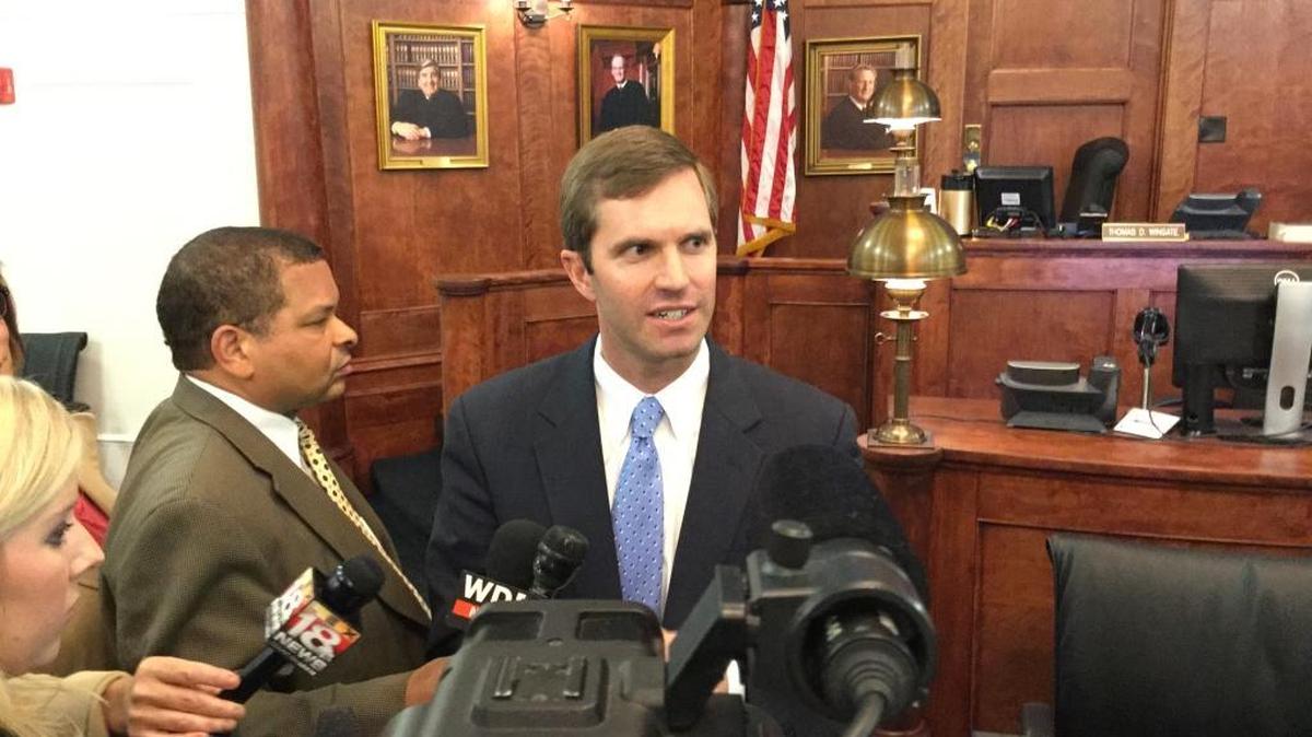 Attorney General Andy Beshear talks to reporters about his lawsuit to block Gov. Matt Bevin’s mid-year budget cuts to Kentucky’s universities and colleges on Thursday.