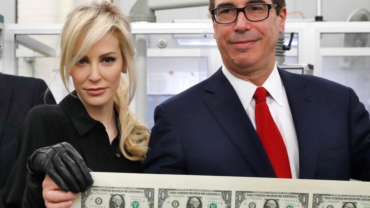 Treasury Secretary Steven Mnuchin and his wife Louise Linton in mid-November held up a sheet of new $1 bills, the first currency notes bearing his and U.S. Treasurer Jovita Carranza's signatures.