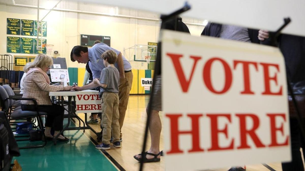 A voter signed in at the Fontaine precinct before casting his ballot in the 2016 general election at Morton Middle School in Lexington, Ky., Tuesday, November 8, 2016.