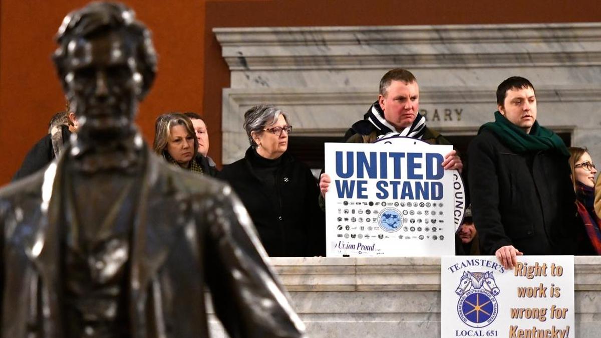 Union members listen in as protesters fill the Kentucky Capitol rotunda to speak in protest of Kentucky House Bill 1, Saturday, Jan. 7, 2017, in Frankfort, Ky. The bill, which lets workers avoid paying union dues even if they get the benefits of a union-negotiated workplace contract, was passed by the Senate, and now awaits the Governor’s signature. (AP Photo/Timothy D. Easley)