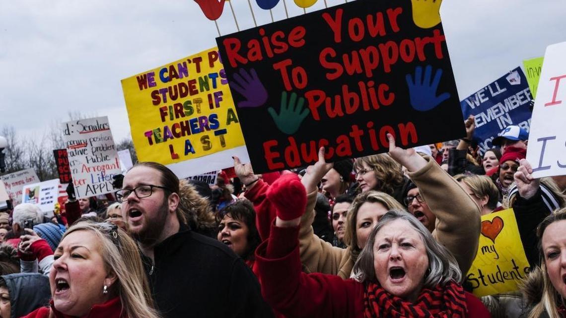 Teachers and other supporters rally against Senate Bill 1, a pension overhaul bill, on the Capitol steps in Frankfort, Ky. on Monday, March 12, 2018.