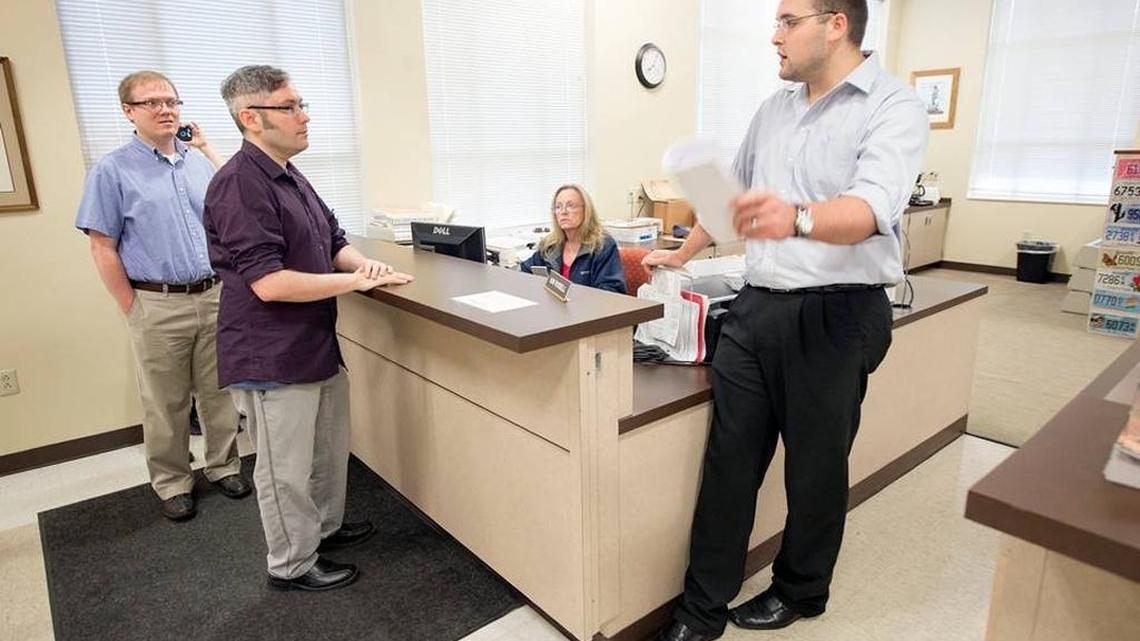 Rowan County Deputy Clerk Nathan Davis, right, informed David Moore, center, and David Ermold in August 2015 that he wouldn’t issue them a marriage license. Nathan Davis’ mother, County Clerk Kim Davis, said she objected to same-sex marriage because of her religious beliefs.