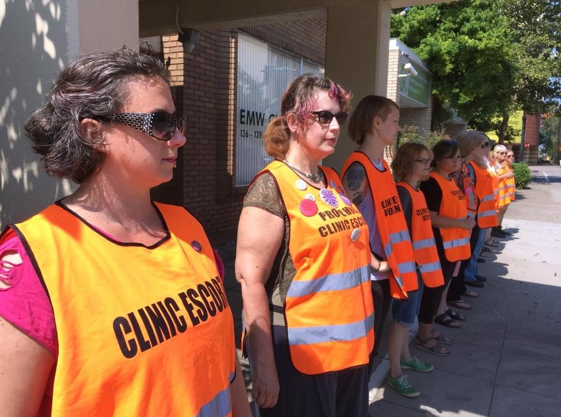 In this 2017 photo, Meg Stern, left, and other escort volunteers lined up outside the EMW Women’s Surgical Center in Louisville. The escorts were preparing for a large anti-abortion protest seeking to shut down the center, the last one providing abortions in the state of Kentucky.
