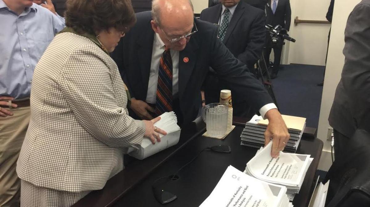 Kentucky budget director John Chilton and Jennifer Hans, a staffer with the Public Pension Oversight Board, check copies on Monday, Aug. 28, 2017, of the recommendations to attack the state’s financially strapped public pension systems.