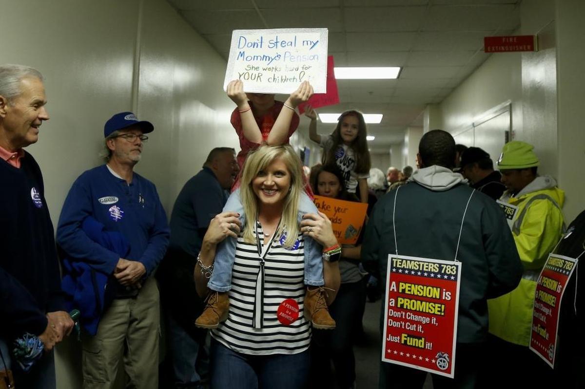 Retirees and teachers protest prior to a Senate State and Local Government Committee meeting to consider Senate Bill 1, a pension overhaul plan, at the Kentucky State Capitol Annex in Frankfort, Ky., on February 28, 2018.