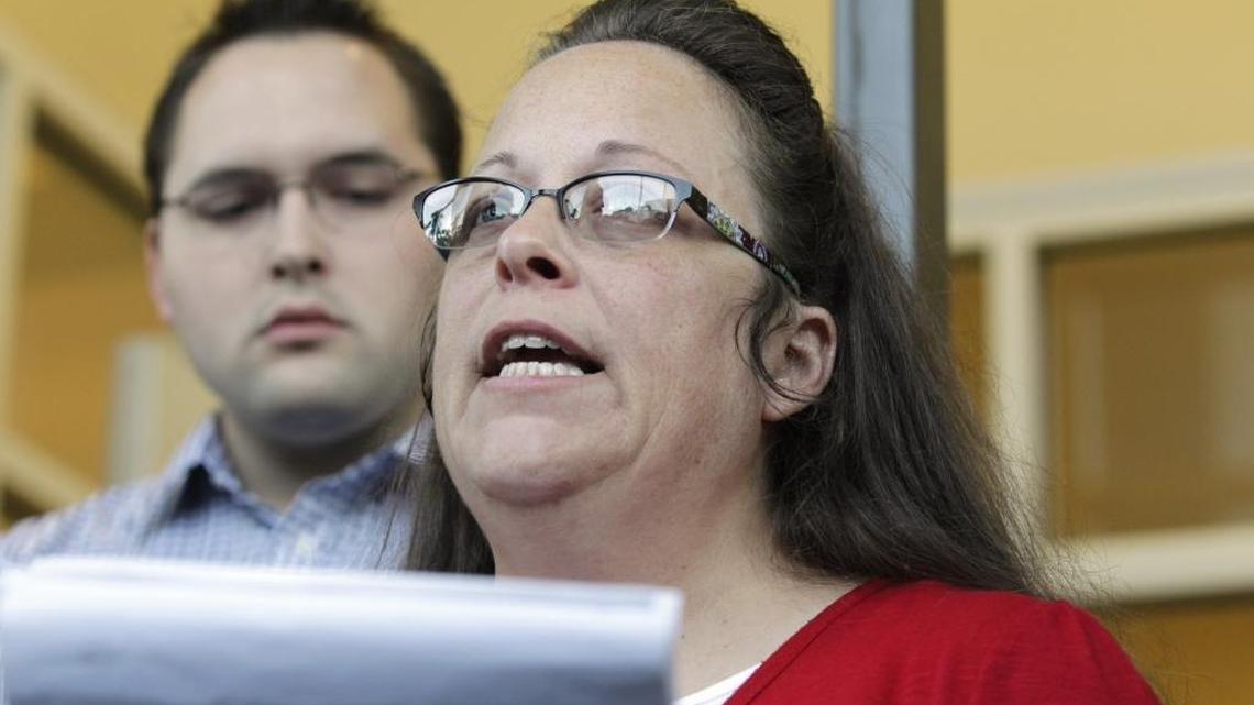 Rowan County Clerk Kim Davis, with son Nathan Davis, a deputy clerk, read a statement to the media on Sept. 14, 2015 outside the Rowan County Courthouse in Morehead. It was her first day back at work after spending five days in jail for contempt after defying a federal judge’s order to issue marriage licenses to same-sex couples.