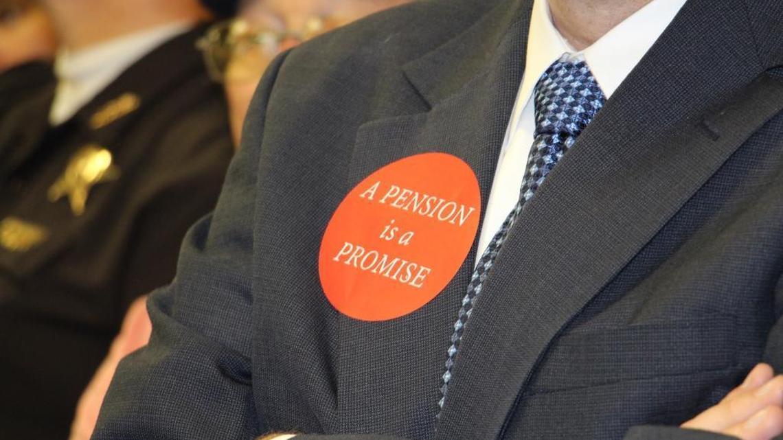 An audience member wears a sticker supporting state workers as a consultant hired by the Bevin Administration presented recommendations for overhauling Kentucky’s financially-ailing pension systems on Aug. 28, 2017.