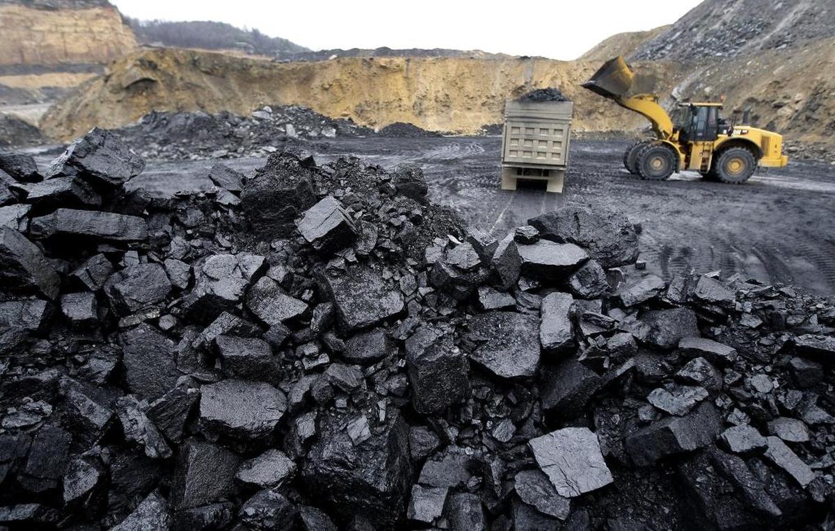 Ray Sizemore operated a loader to load coal on a truck at a Pine Branch Coal Sales surface mine near Chavies, Ky., Friday, December 19, 2008.