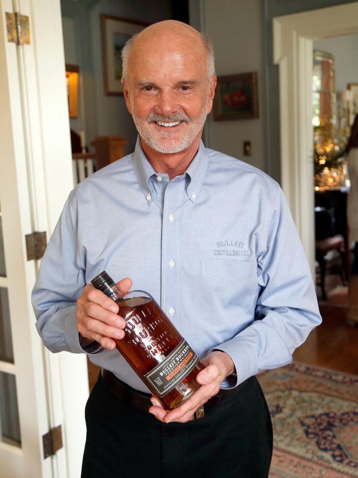 Tom Bulleit, founder of the Bulleit brand, with a bottle of Bulleit Bourbon Barrel Strength, in his home in Lexington.