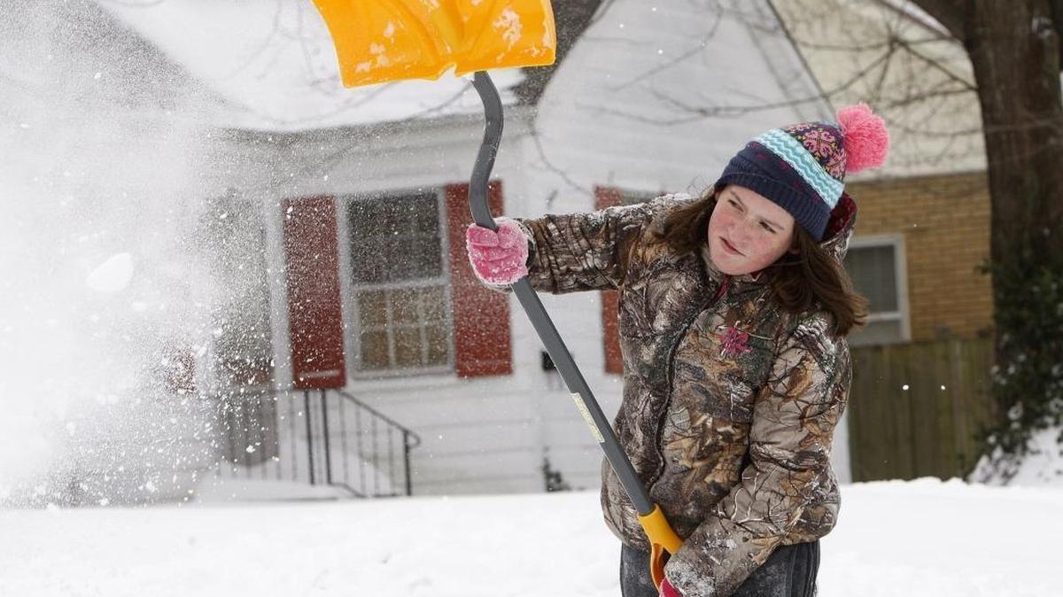 Felicity Trosper, 12, helped shovel snow Sunday at her grandmother’s home on Highland Park Drive in Lexington.