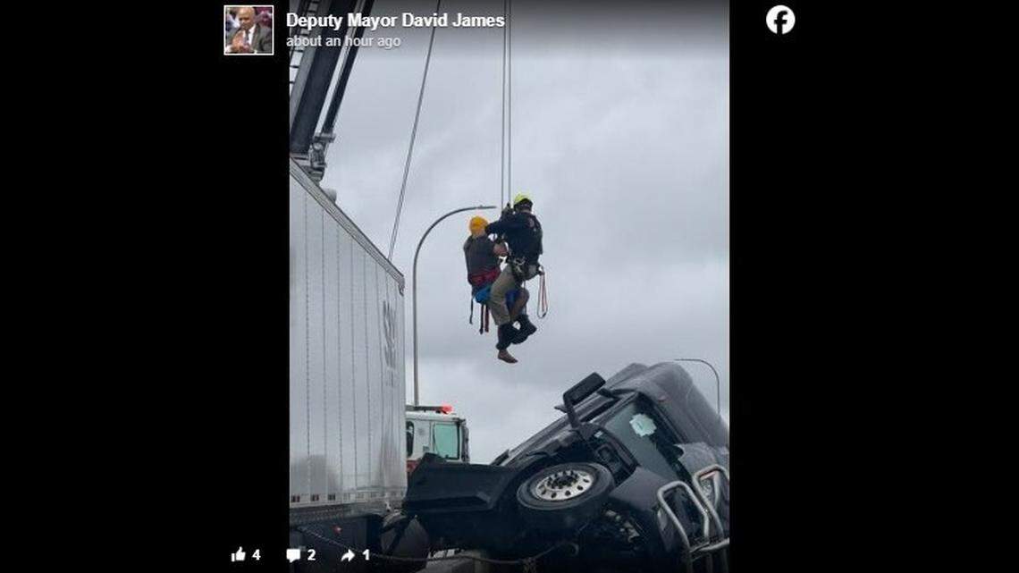 A semitruck driver was rescued after a crash left the cab hanging off an overpass.