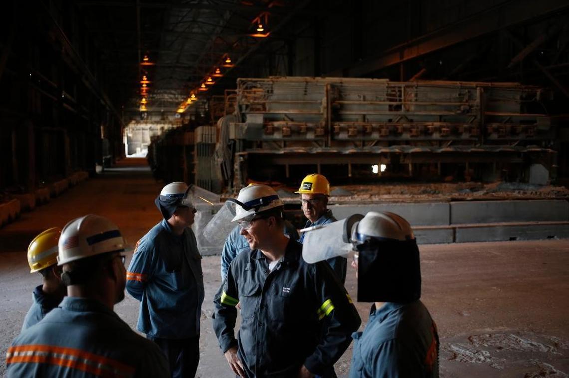 Pot room manager Seth Augustine, center, spoke to fellow employees.