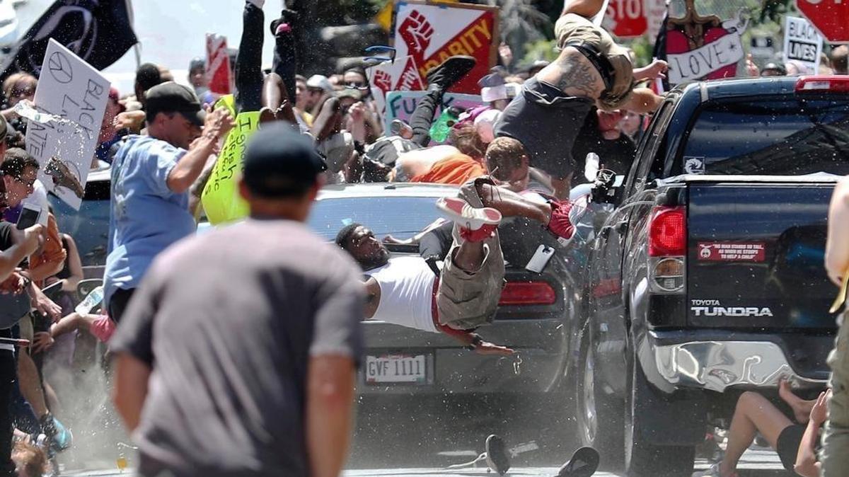 In this Aug. 12, 2017 file photo, people flew into the air as a vehicle was driven into a group of protesters demonstrating against a white nationalist rally in Charlottesville, Va. James Alex Fields Jr., who was raised in Kentucky, was the driver. He pleaded guilty on March 27, 2019, to federal hate crimes in the attack after a state jury convicted him of murder in December.