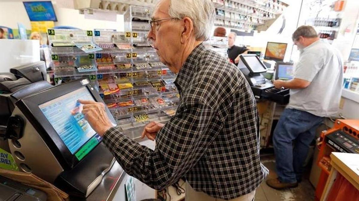 In this file photo, owner Eddie White sold a Powerball ticket at the Dairy Mart at 155 East Reynolds Road in Lexington.