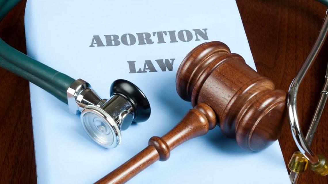 Gavel and stethoscope on Abortion law handbook.
