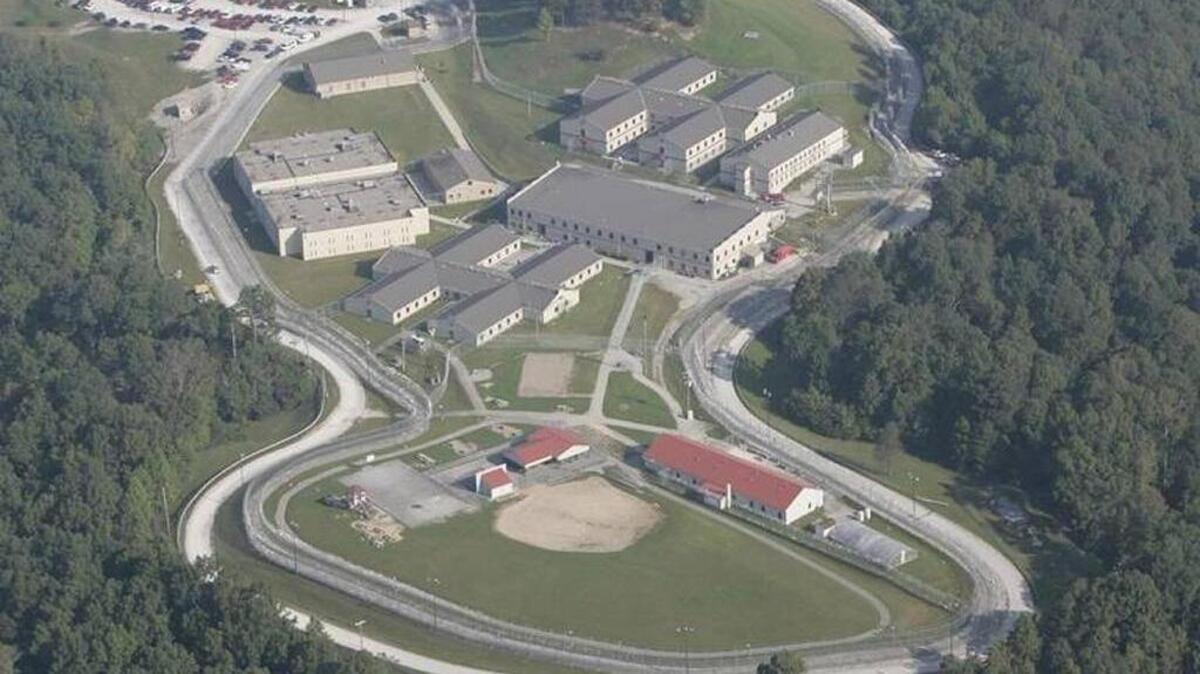 Aerial photograph of the Lee Adjustment Center, owned and operated by Corrections Corporation of America, now known as CoreCivic, following a riot in 2004. Inmates took partial control of the medium-security prison and set fires before authorities regained control.