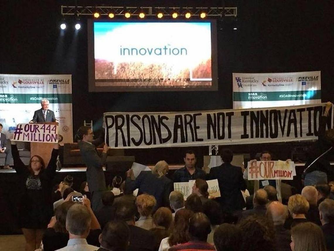 Members of the Letcher Governance Project, a citizens group based in Whitesburg that opposes construction of a federal prison in Letcher County, unfurled a banner in June 2016 during a SOAR Summit while Congressman Hal Rogers was at the podium. Rogers has gotten funding for the prison in the House budget. #our444million refers to its projected cost. Innovation was the theme of the Shaping Our Appalachian Region gathering.