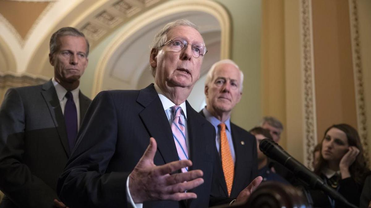 Senate Majority Leader Mitch McConnell, R-Ky., flanked by Sen. John Thune, R-S.D., left, and Majority Whip John Cornyn, R-Texas, spo with reporters about Supreme Court nominee Brett Kavanaugh on Tuesday.