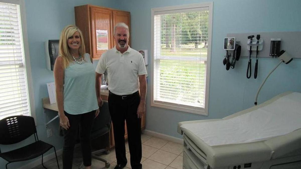 Angie Patton, health and wellness director at Laurel Grocery Co., and CEO Winston Griffin in the on-site primary-care clinic that is saving the London company money on health care while increasing productivity.