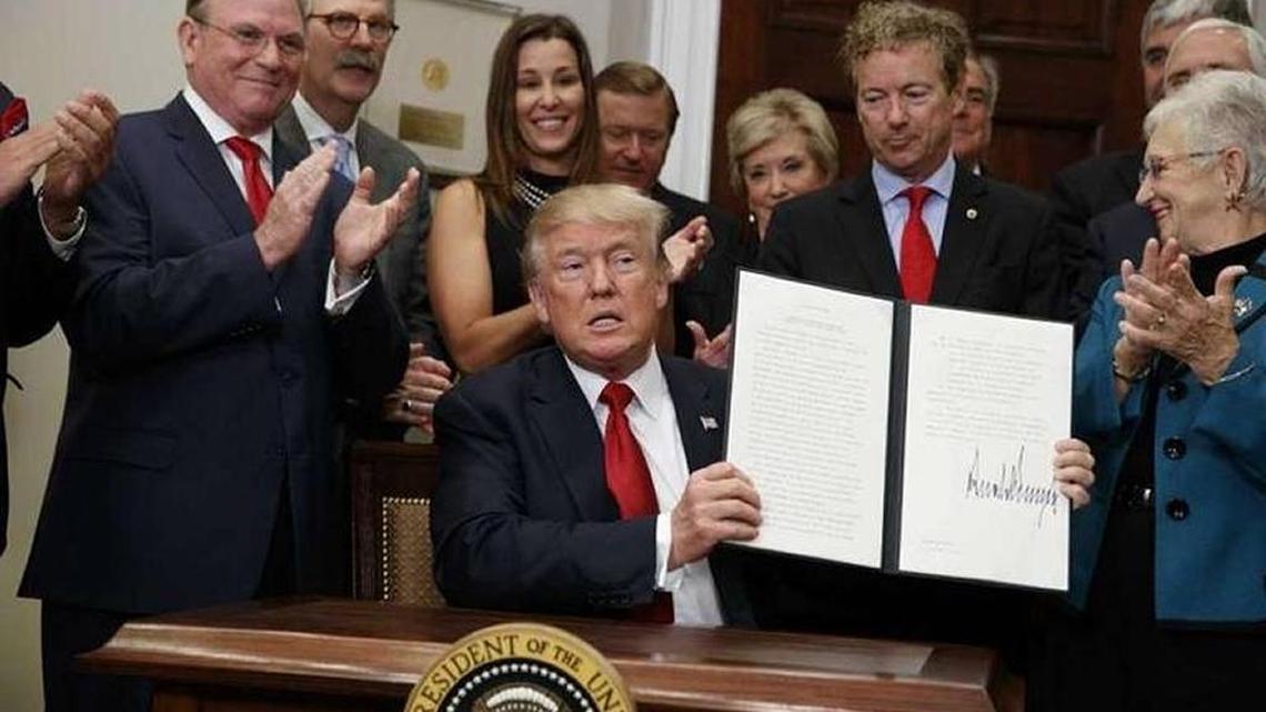 President Donald Trump signed an order Oct. 12 ending subsidies to reduce out-of-pocket medical costs for low-income Americans. Sen. Rand Paul, R-Kentucky, looked over Trump’s left shoulder.