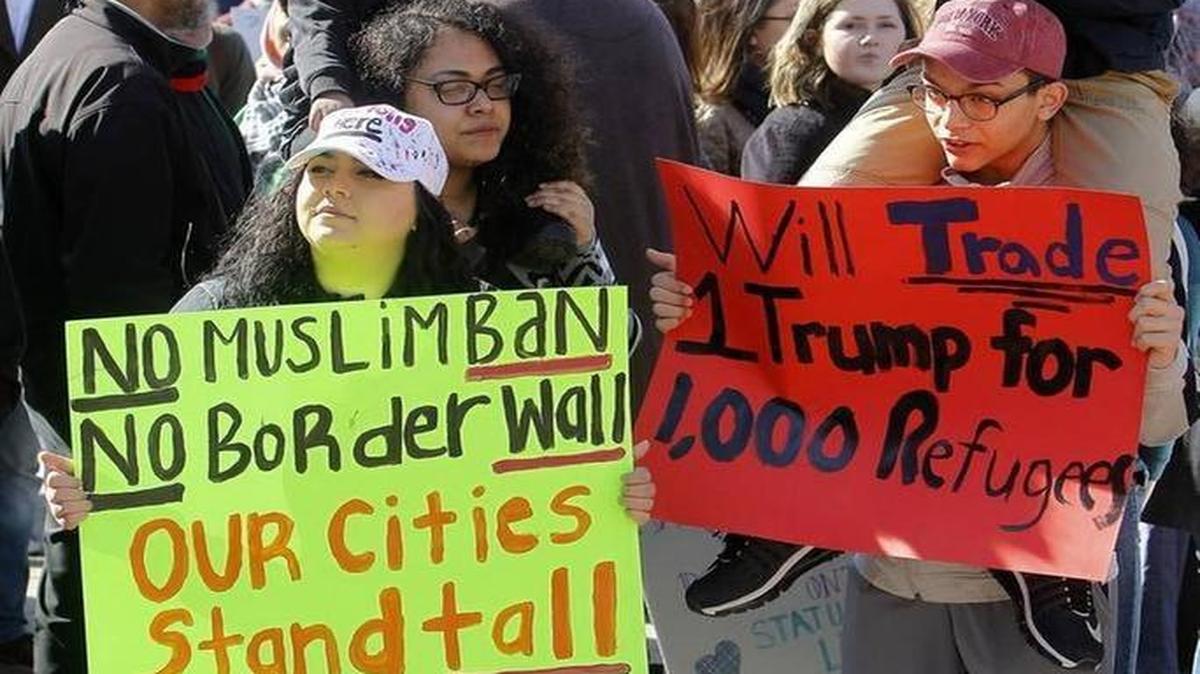 Participants held signs during the Feb. 5 Protest the Immigration Ban rally, organized by area high school students, at Lexington’s Courthouse Plaza.