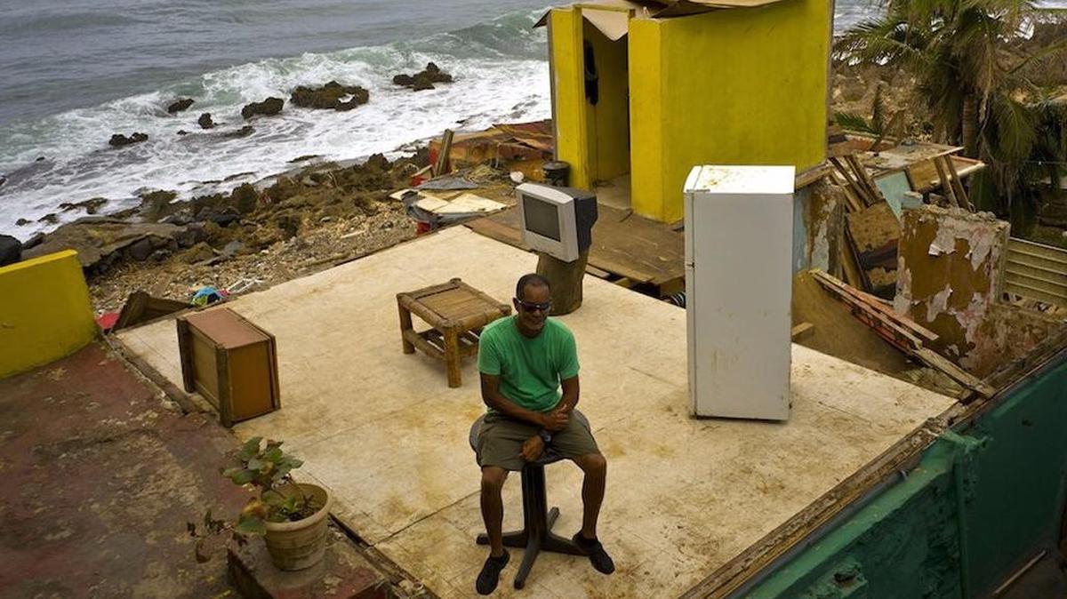 Roberto Figueroa Caballero sits in what’s left of his home after Hurricane Maria hit the coast of San Juan, Puerto Rico.