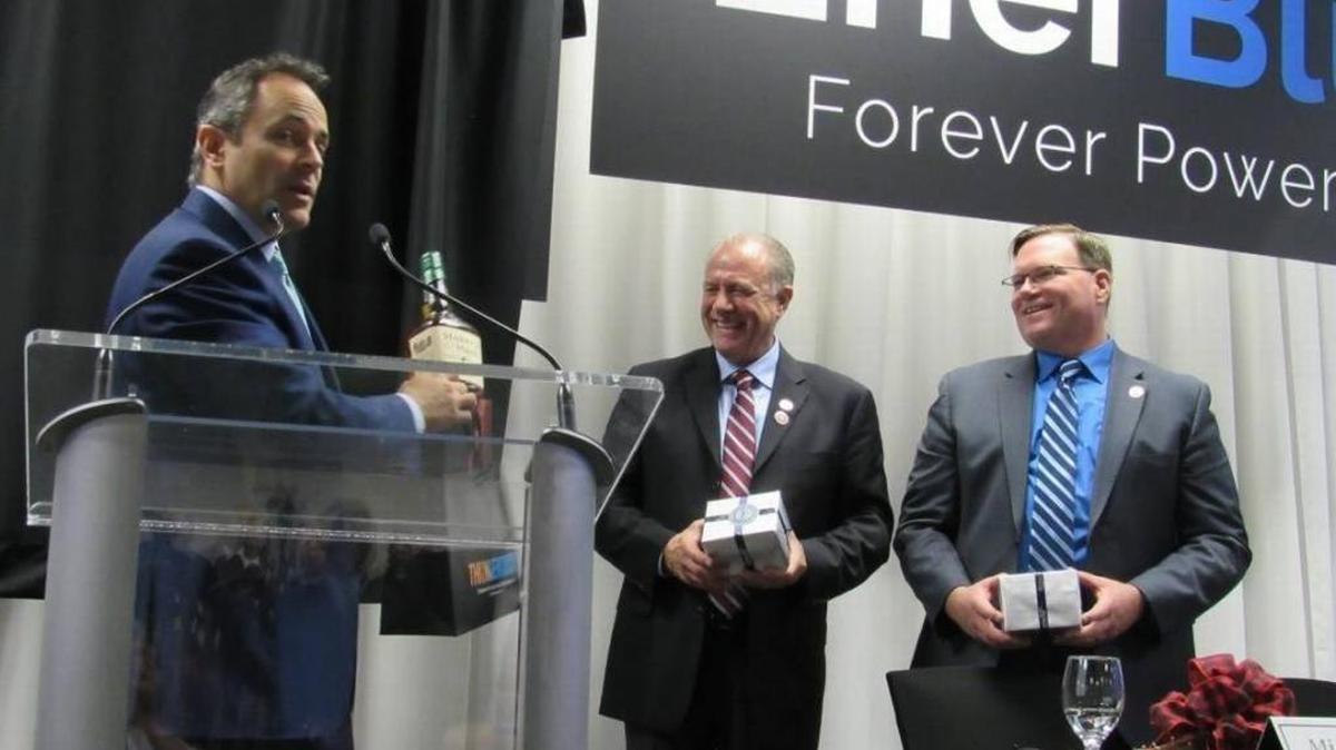 Gov. Matt Bevin on Dec. 15 presented a bottle of bourbno to executives of Enerblu, which plans to build a battery-manufacturing plant in Pikeville with headquarters in Lexington. At center is Michael Weber and Daniel Elliott, president and CEO.