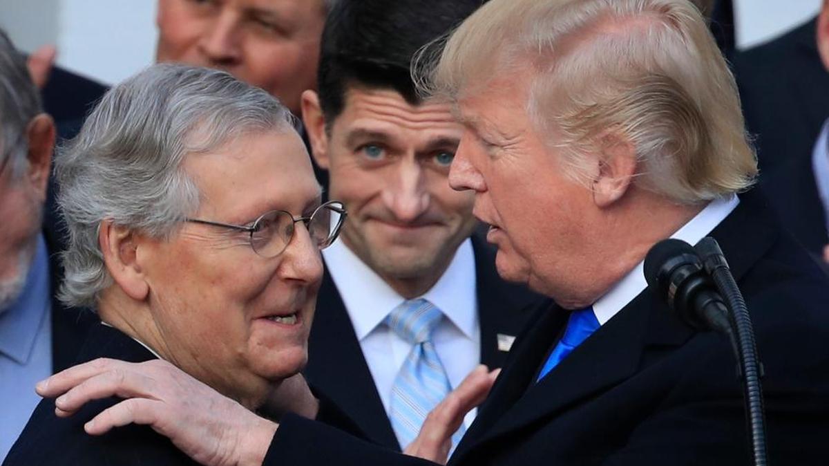 President Donald Trump congratulated Senate Majority Leader Mitch McConnell while House Speaker Paul Ryan looked on during a December ceremony after the final passage of tax overhaul legislation.