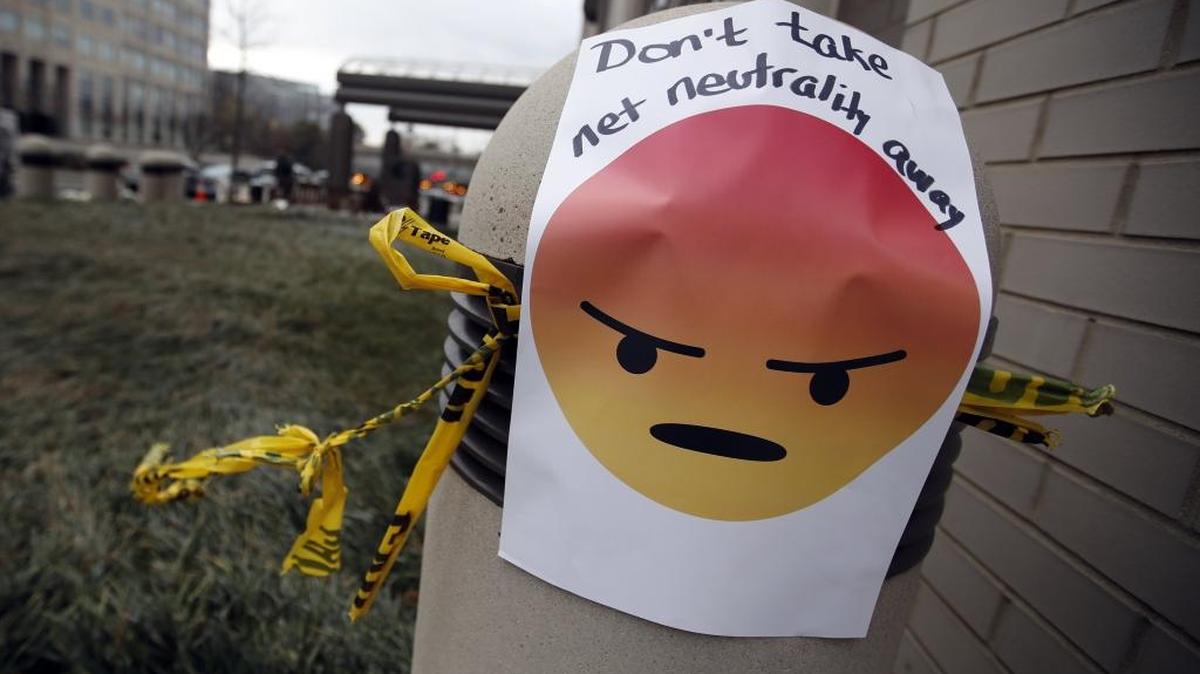 A sign with an emoji reads "Don't take net neutrality away" was posted outside the Federal Communications Commission in Washington, Thursday as the FCC voted to eliminate net-neutrality protections for the internet.