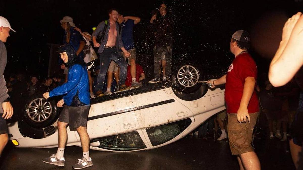 Revelers stood atop an overturned car on State Street in Lexington following Kentucky’s 27-16 win at Florida on Sept. 8, ending a 31-year losing streak.