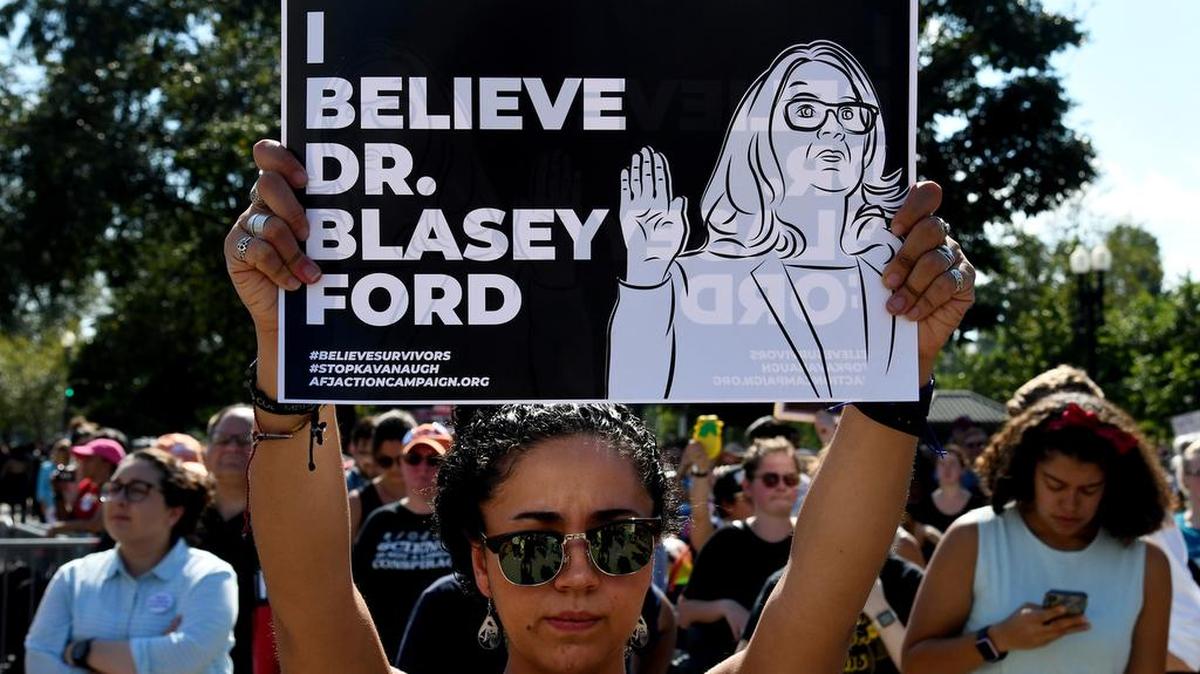 Protesters held up signs during a protest against U.S. Supreme Court nominee Brett Kavanaugh on Thursday in Washington, D.C.