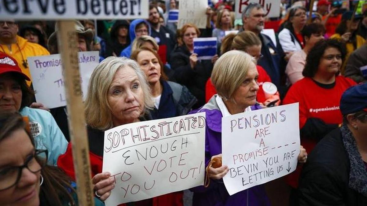 Retired teachers Jewell Montgomery, of Burgin, left and Everice Shewmaker, of Harrodsburg, listened to speakers during a rally against the Republican proposal to reform the state's pension system outside of the Capitol on Nov. 1.
