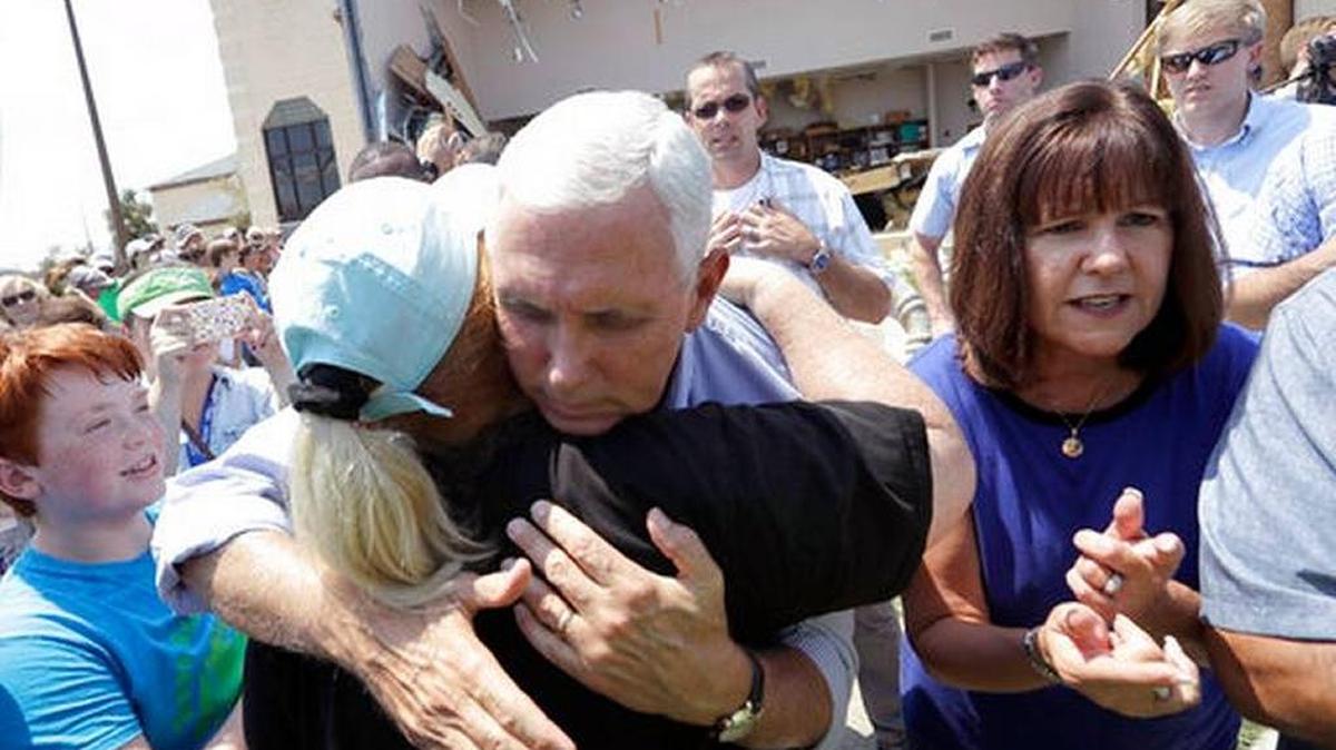 Vice President Mike Pence, center, with his wife Karen, right, shared a hug as he tries to encourage residents effected by Hurricane Harvey during an Aug. 31 visitin Rockport, Texas.