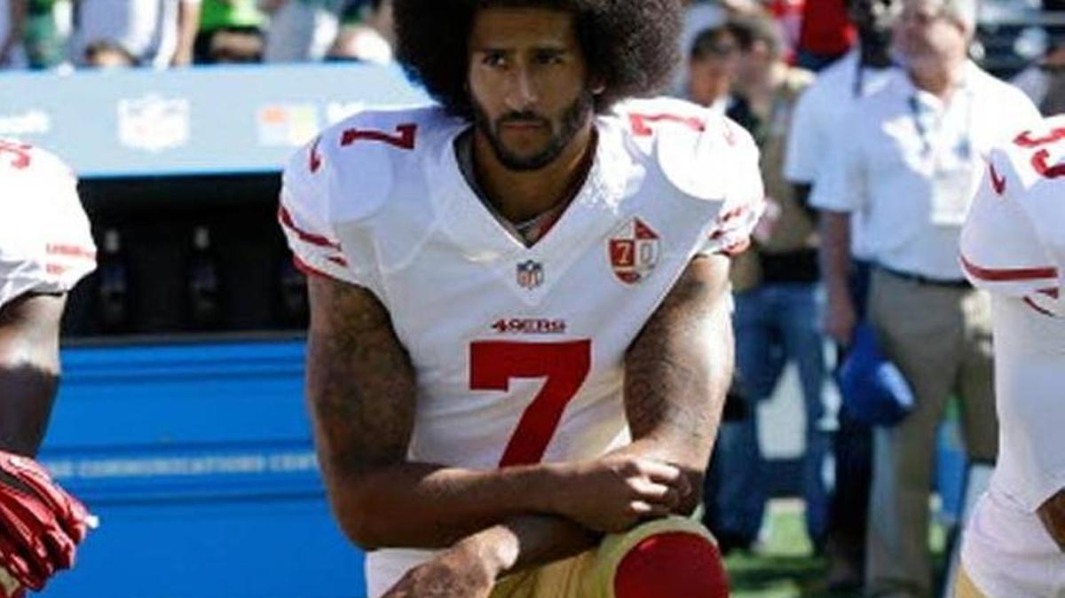 Colin Kaepernick, then quarterback for the San Francisco 49ers, protested racial injustice by kneeling during the national anthem before an NFL football game in Seattle in 2016.