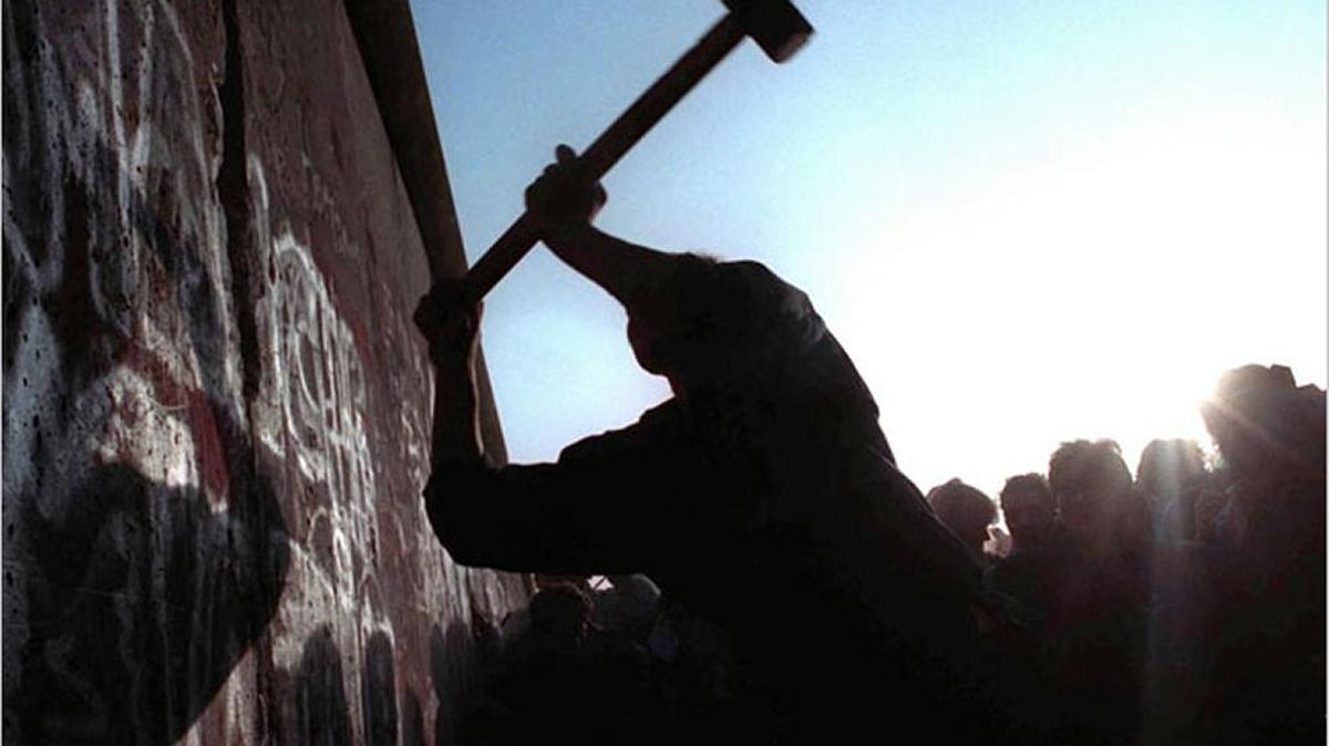 A man hammered at the Berlin Wall, the 28-year border barrier between East and West Germany. It was opened by government officials in 1989.