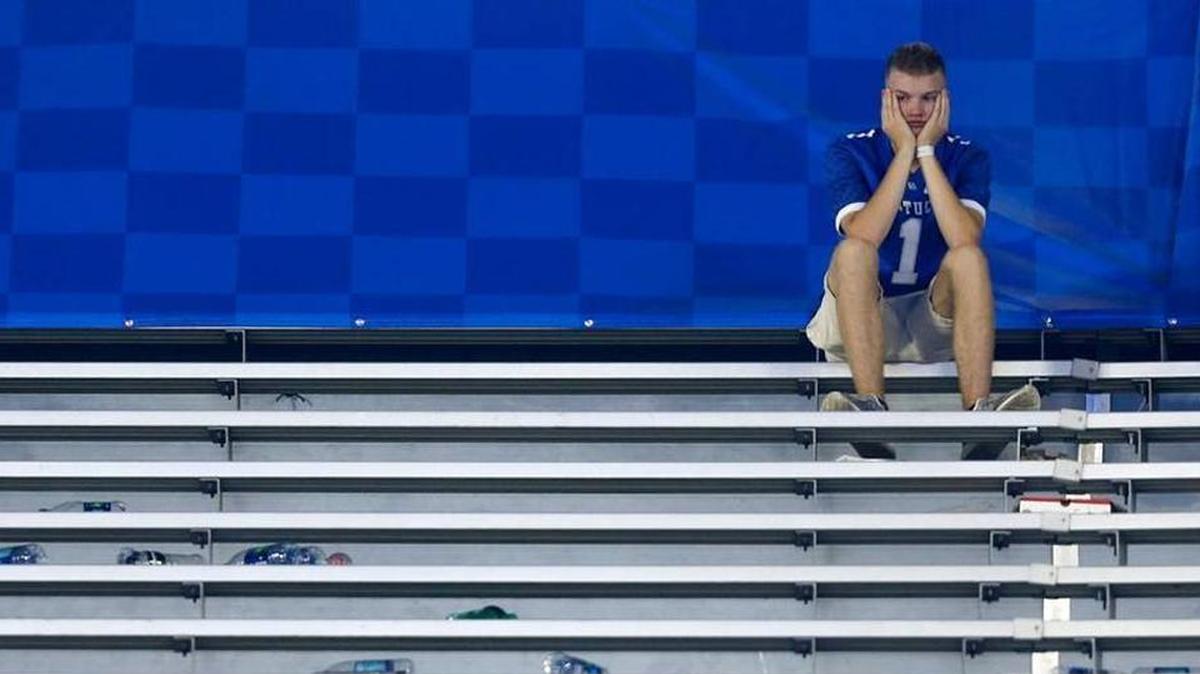 A dejected fan sat in the stands Saturday night after the University of Kentucky football team’s 28-27 loss to the University of Florida.