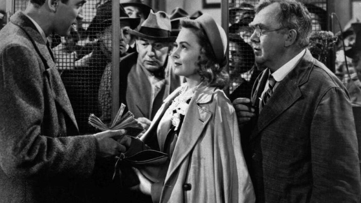 James Stewart, left, Thomas Mitchell, right, and Donna Reed appear in a scene from the 1946 film "It's A Wonderful Life."