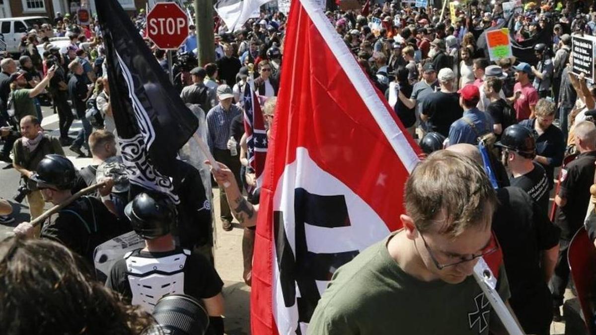 A white supremacist carried a Nazi flag during a protest in Charlottesville, Va. in August.