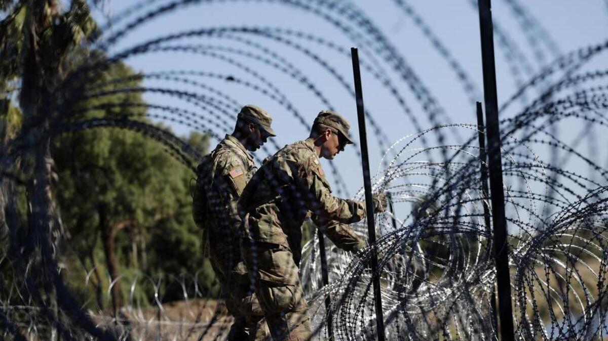 Members of the U.S. military installed multiple tiers of concertina wire along the banks of the Rio Grande near the Juarez-Lincoln Bridge at the U.S.-Mexico border on Nov. 16 in Laredo, Texas.