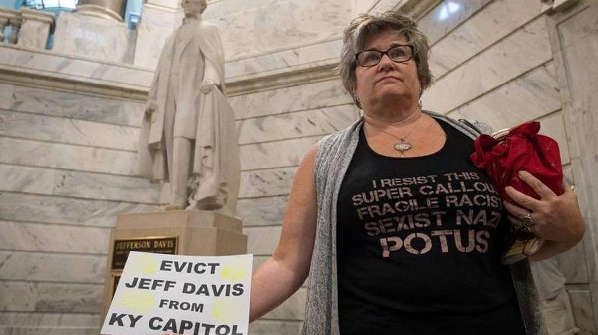 Mary West, of Frankfort, stood in front of the statue of Jefferson Davis at the Kentucky Capitol during an Aug. 16 rally to support the victims of Charlottesville, Va., and to call for the removal of the Jefferson Davis statue from the Capitol Rotunda.
