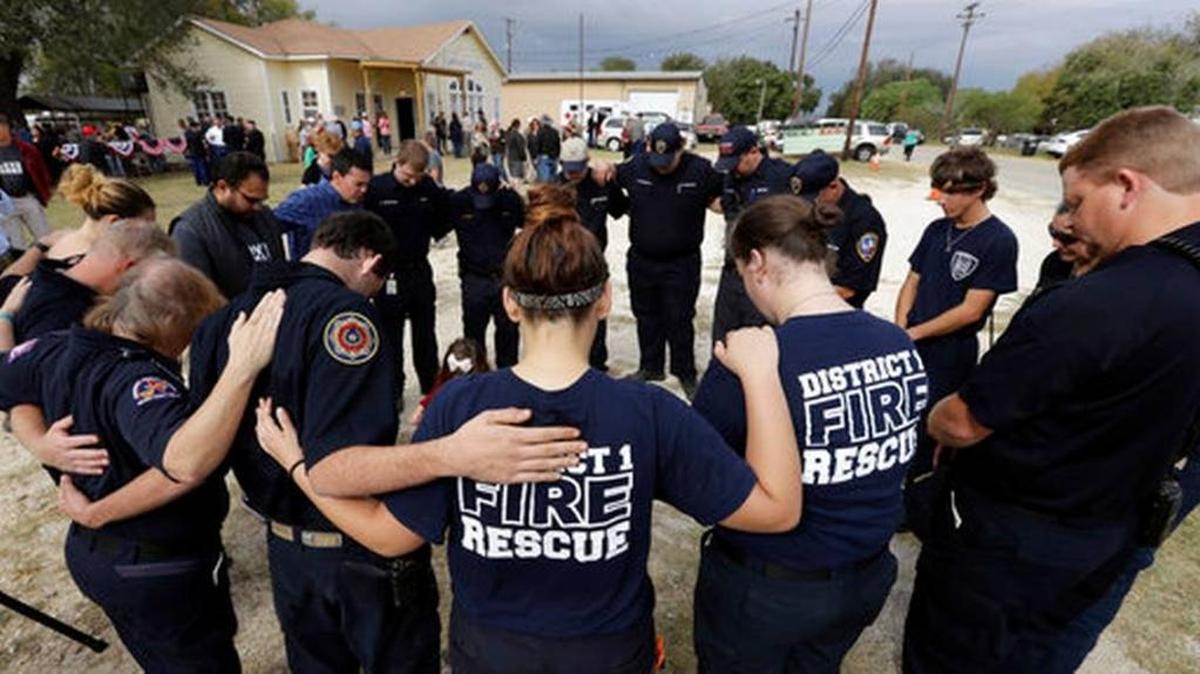 First responders join in prayer following a Veterans Day event, Saturday, Nov. 11, 2017, near the Sutherland Springs First Baptist Church, in Sutherland Springs, Texas. A man opened fire inside the church in the small South Texas community, killing more than two dozen.