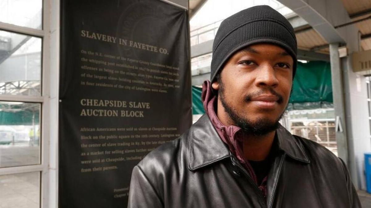 DeBraun Thomas, one of the co-founders of Take Back Cheapside, stood next to explanatory text in the Fifth Third Bank Pavilion at Cheapside Park in Lexington on Dec. 18.
