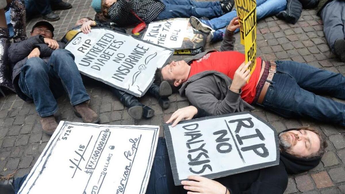 Demonstrators created a “die in” in front of the New York Stock Exchange to protest the GOP’s tax plan on Tuesday.