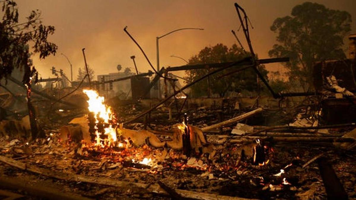Flames rise from the remains of a burned down commercial building in Santa Rosa, Calif., Oct. 9, 2017.