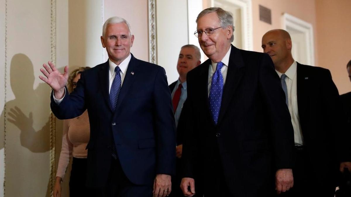 Senate Majority Leader walks with Vice president-elect Mike Pence after a Thursday meeting on Capitol Hill.
